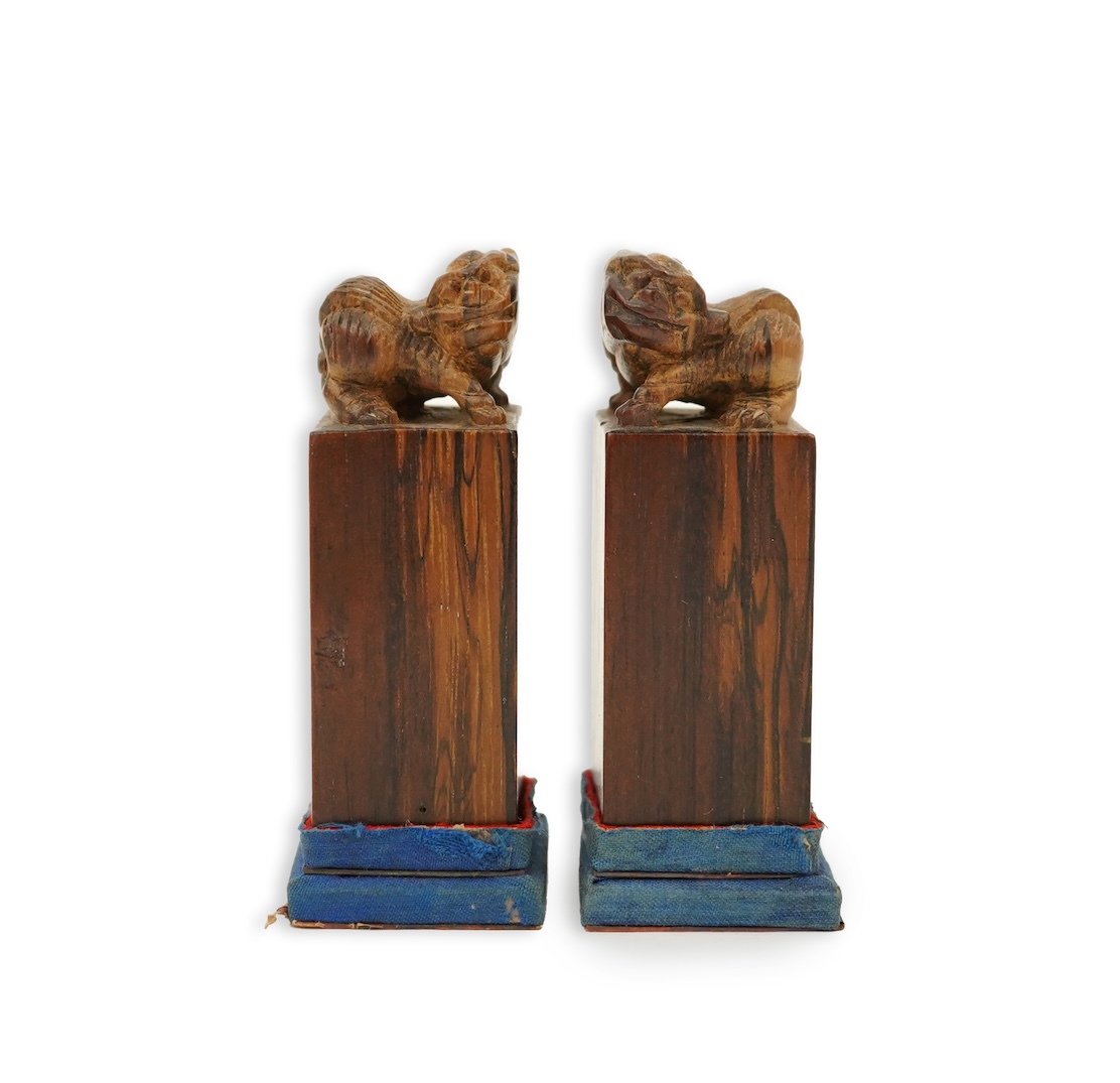A cased pair of Chinese hardwood ‘lion-dog’ seals, early 20th century